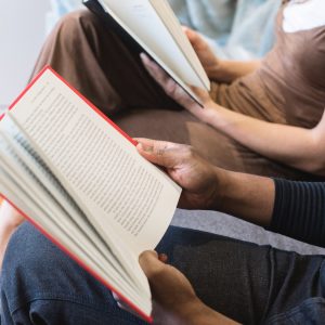 A close up shot of kids reading books.